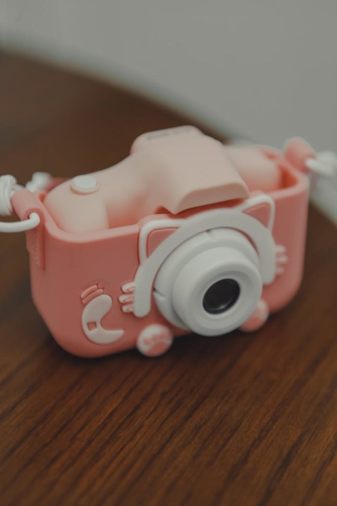 Adorable pink toy camera with a whimsical and playful design, perfect for children.