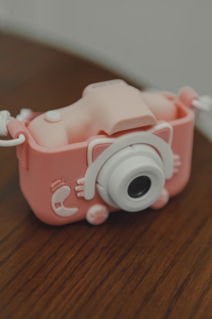 Adorable pink toy camera with a whimsical and playful design, perfect for children.